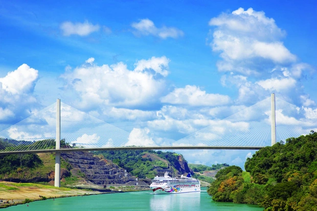 NCL Jewel cruise ship going under a bridge in the panama canal