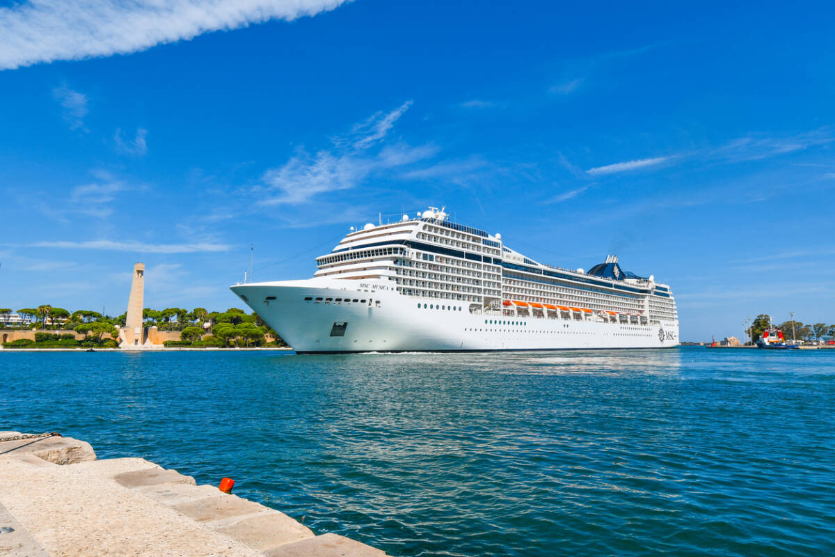 View from the waterfront promenade of MSC Cruise ship liner Musica pulling into the port of Brindisi Italy in the southern Puglia region.