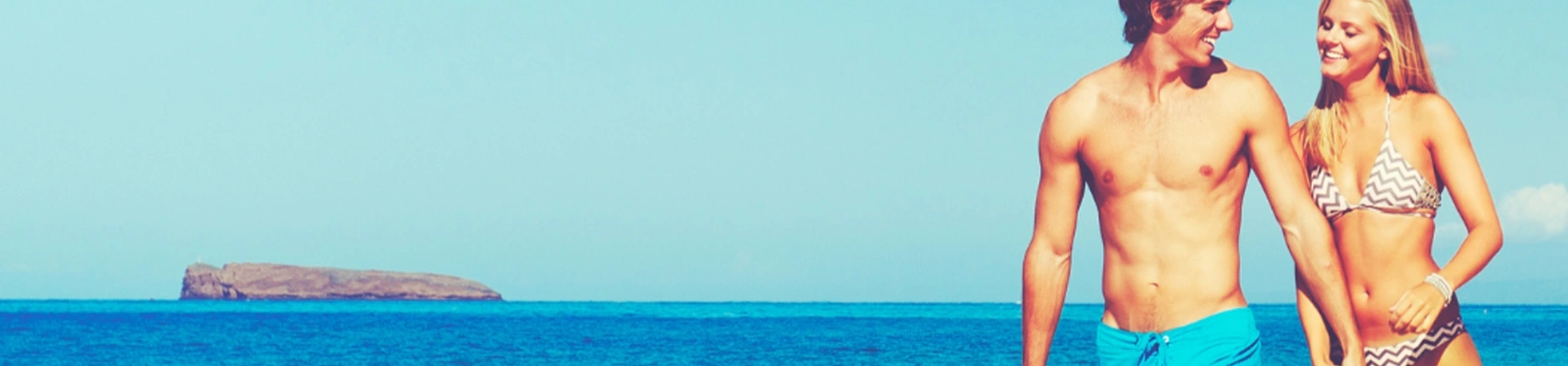 male and female strolling along beach together